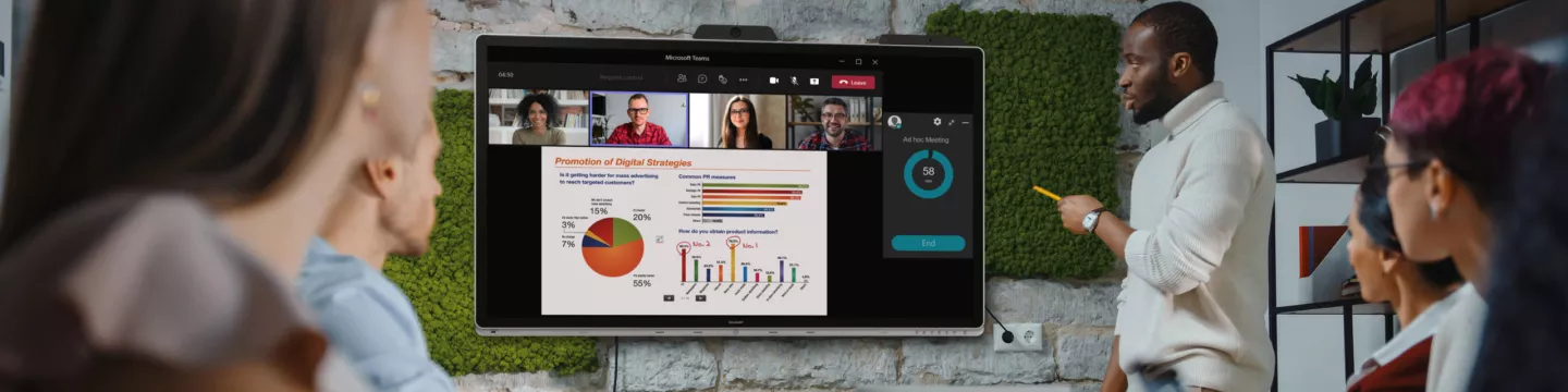 Man presenting at small workgroup hybrid meeting